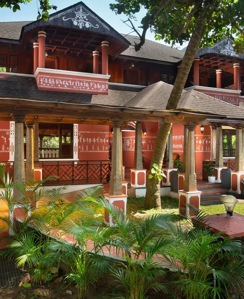 Traditional Ayurveda retreat surrounded by greenery